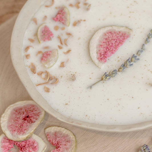 close up view of the centrepiece candle showing the edge of the bowl with the decorative dried fig, lavender and orange blossom