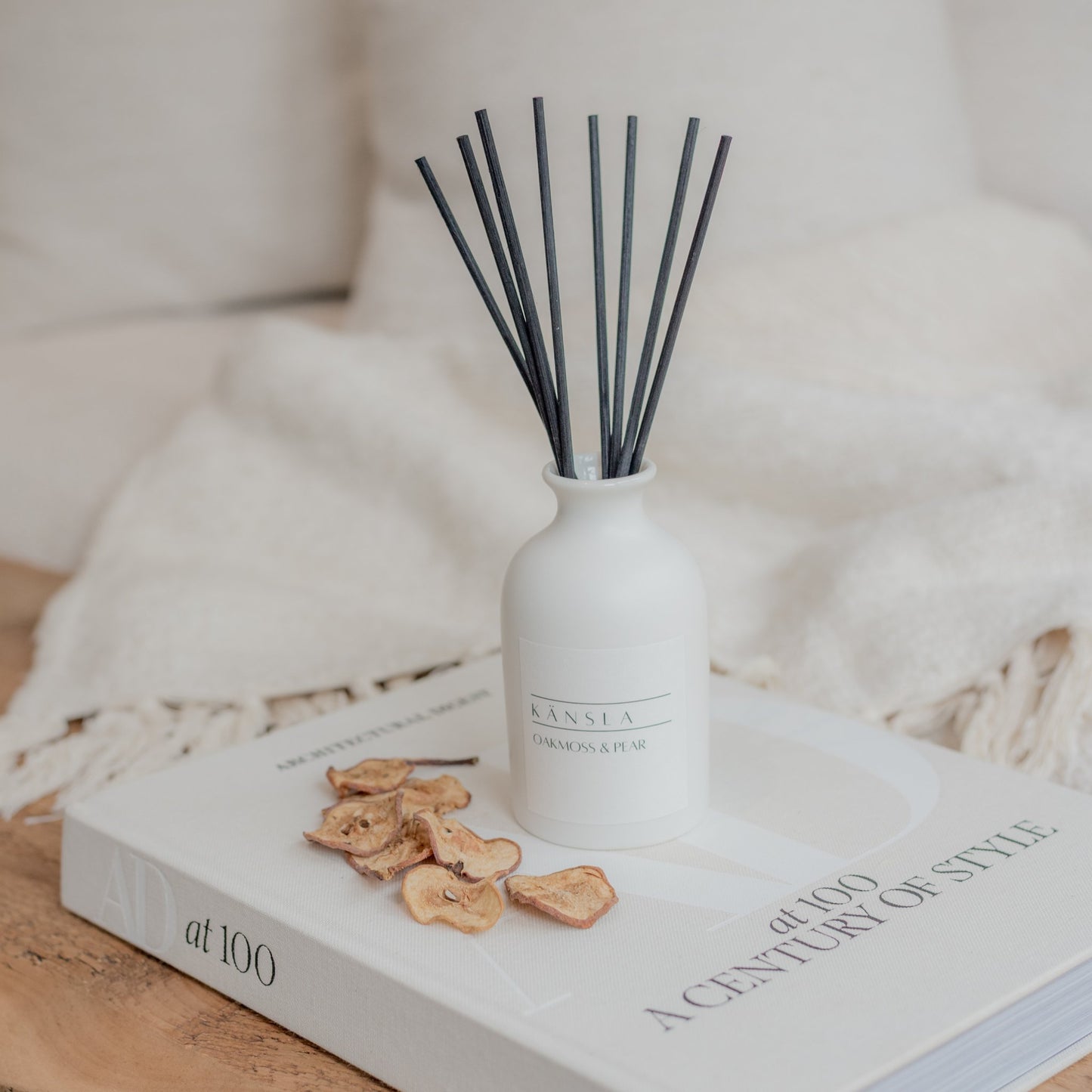 White ceramic reed diffuser with black rattan reeds oakmoss and pear
