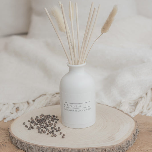 white ceramic reed diffuser with natural rattan reeds and decorative dried bunny tails