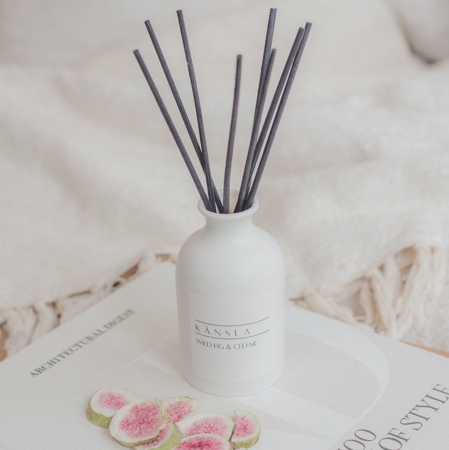 A high angle image of Känsla’s wild fig and cedar reed diffuser with black reeds.