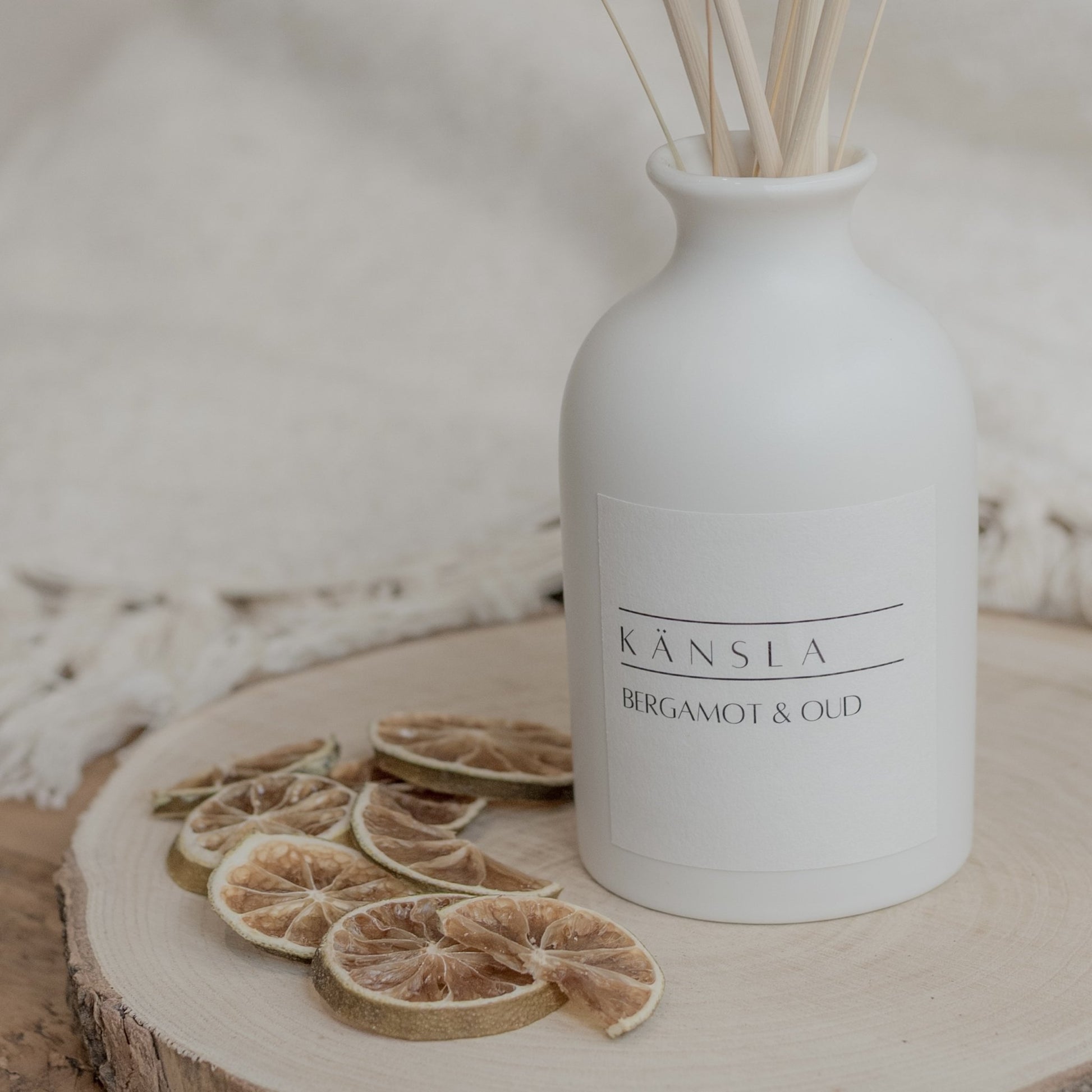 Close up of white ceramic reed diffuser with natural rattan reeds and dried bunny tails
