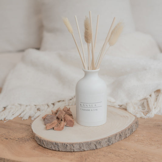 White ceramic reed diffuser with natural reeds and dried bunny tails cashmere and oak